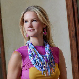 Multi Colored Sequin Scarf Necklace Styled On Maggie in Orange and Pink Dress with Pink Drop Earrings